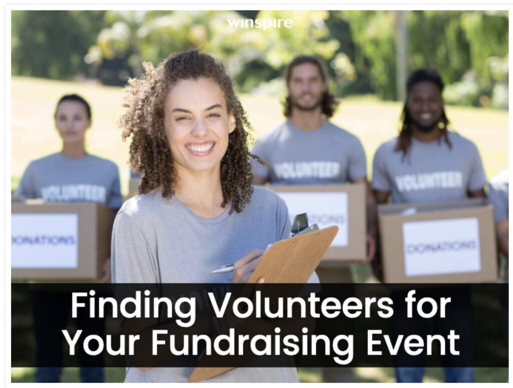 Smiling volunteers hold donation boxes at outdoor fundraising event.
